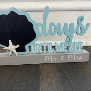 Wedding count down sign with The welcome to our Beginning” sign.